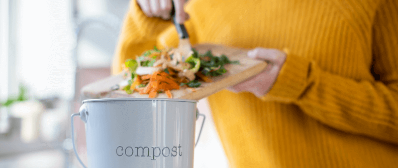 a lady composting food waste