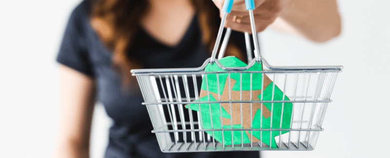 a woman with a recycling logo in a shopping basket
